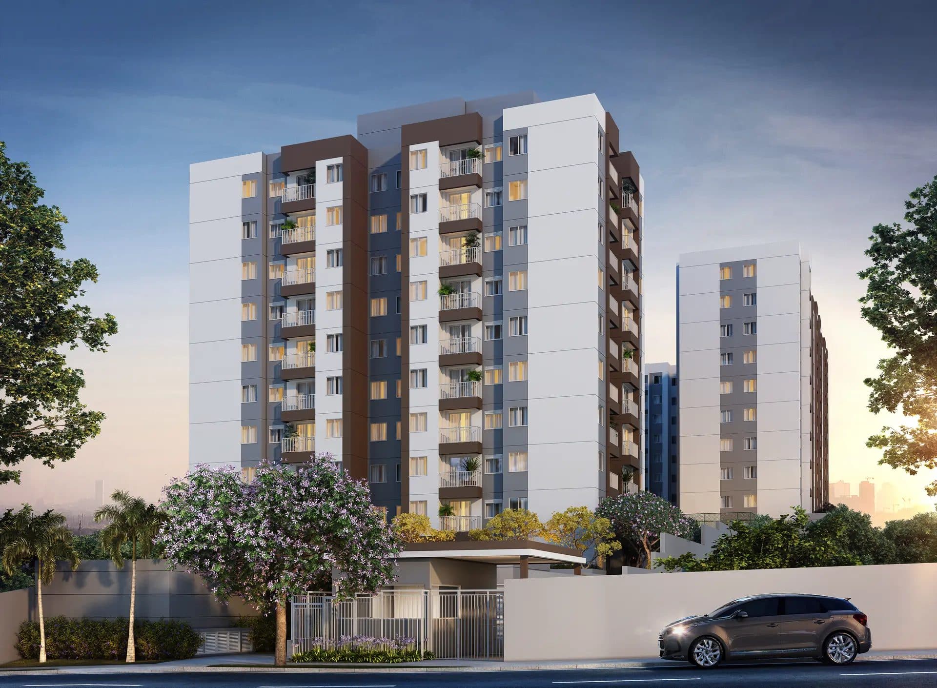 Fachada externa de edifício residencial com varandas e paisagismo.